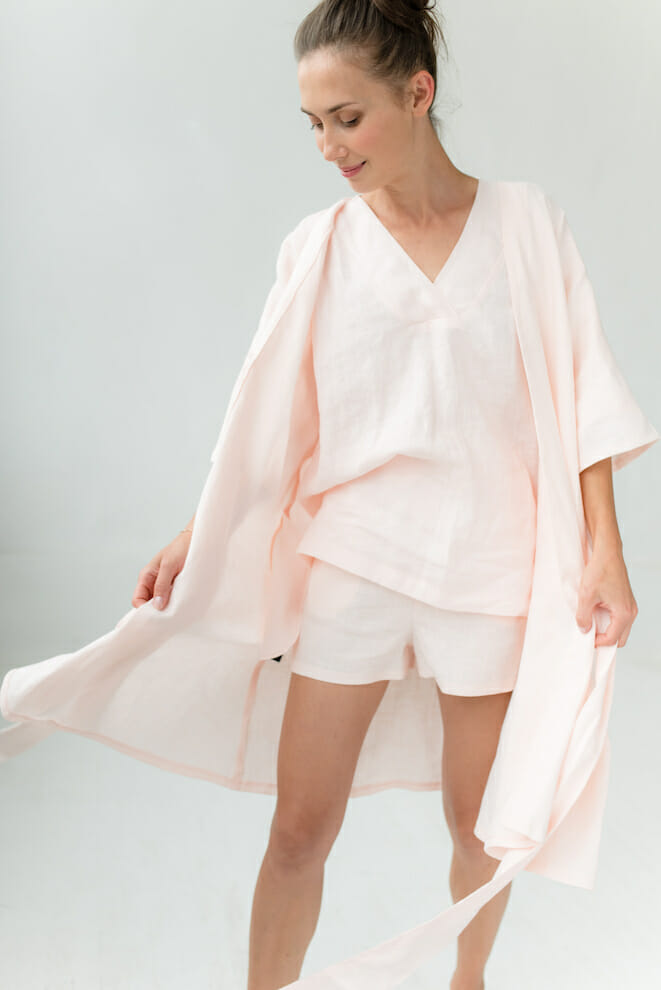 Woman in a pale pink linen robe over a linen top and shorts