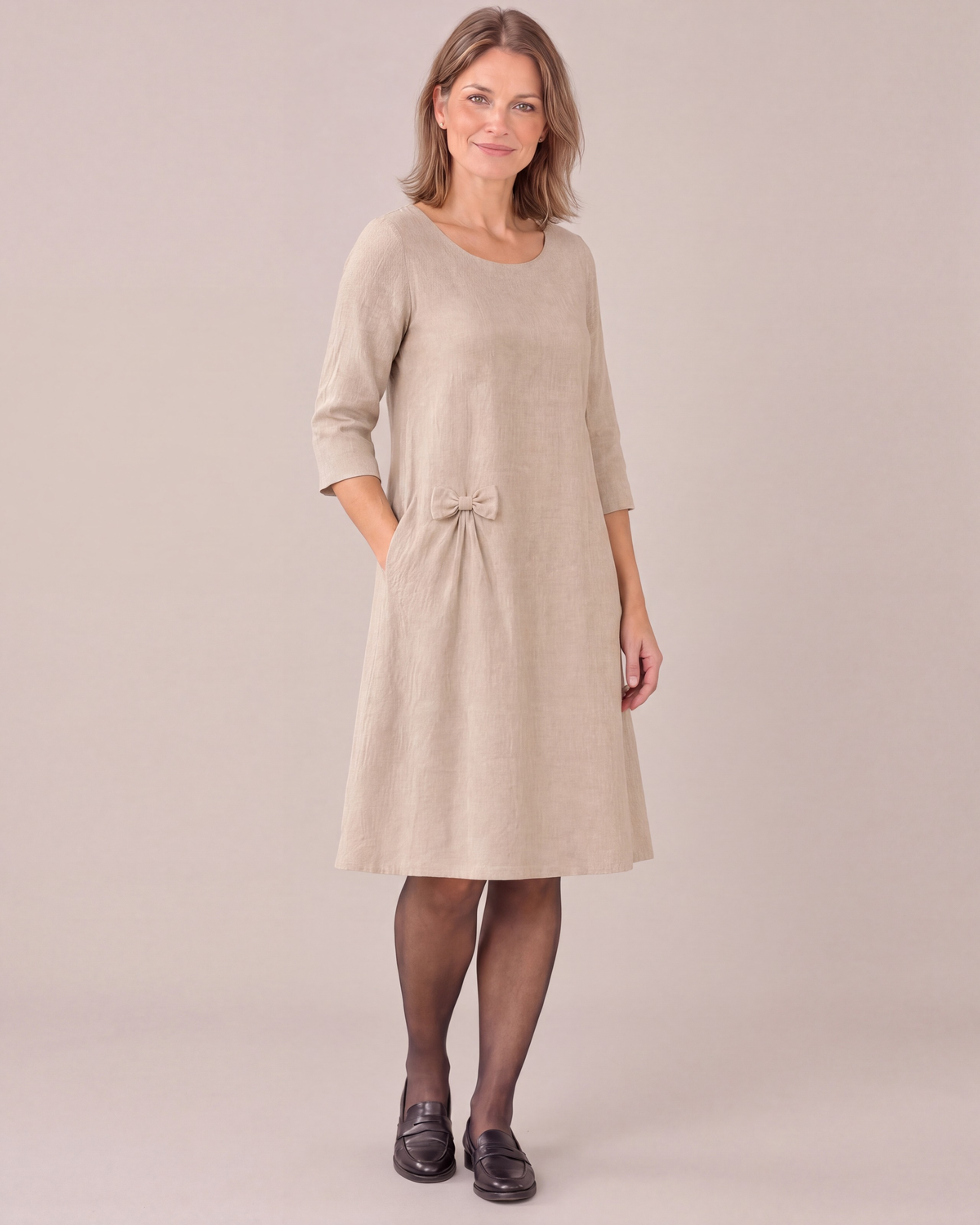 ADELE beige linen swing dress, three-quarter view showing the hip bow