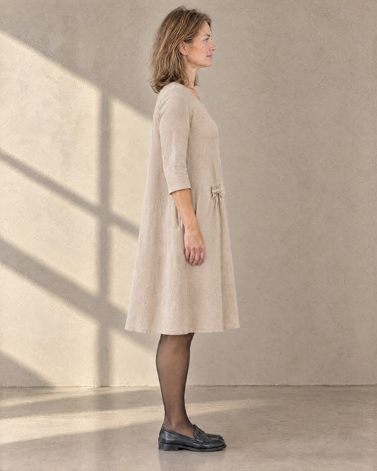 ADELE beige linen swing dress from the side, relaxed swing shape