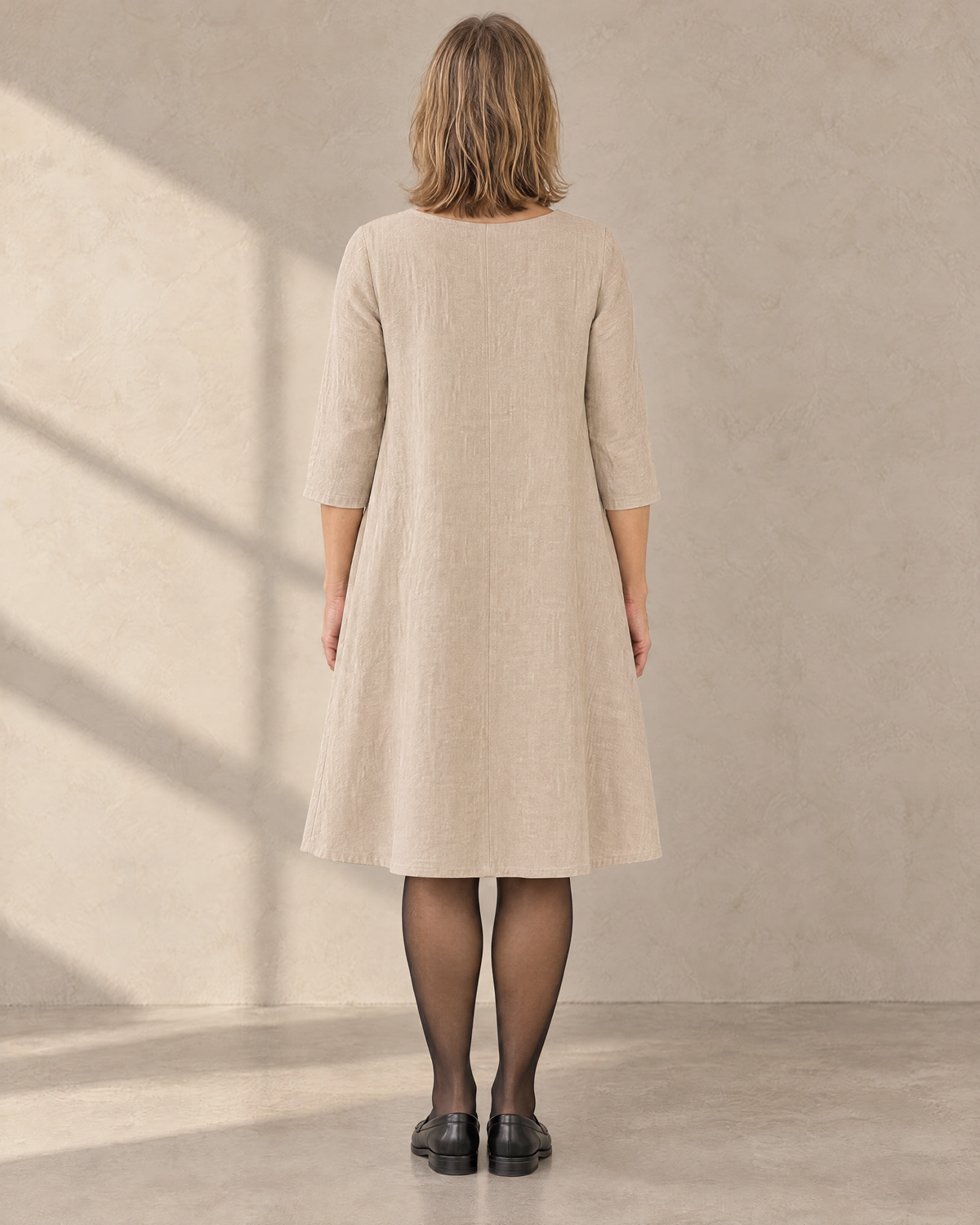 ADELE beige linen swing dress, back view with centre back seam