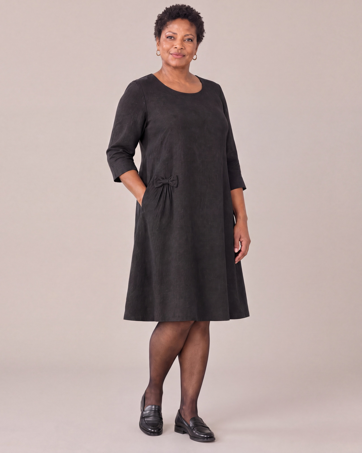 ADELE black linen swing dress with hip bow, three-quarter view