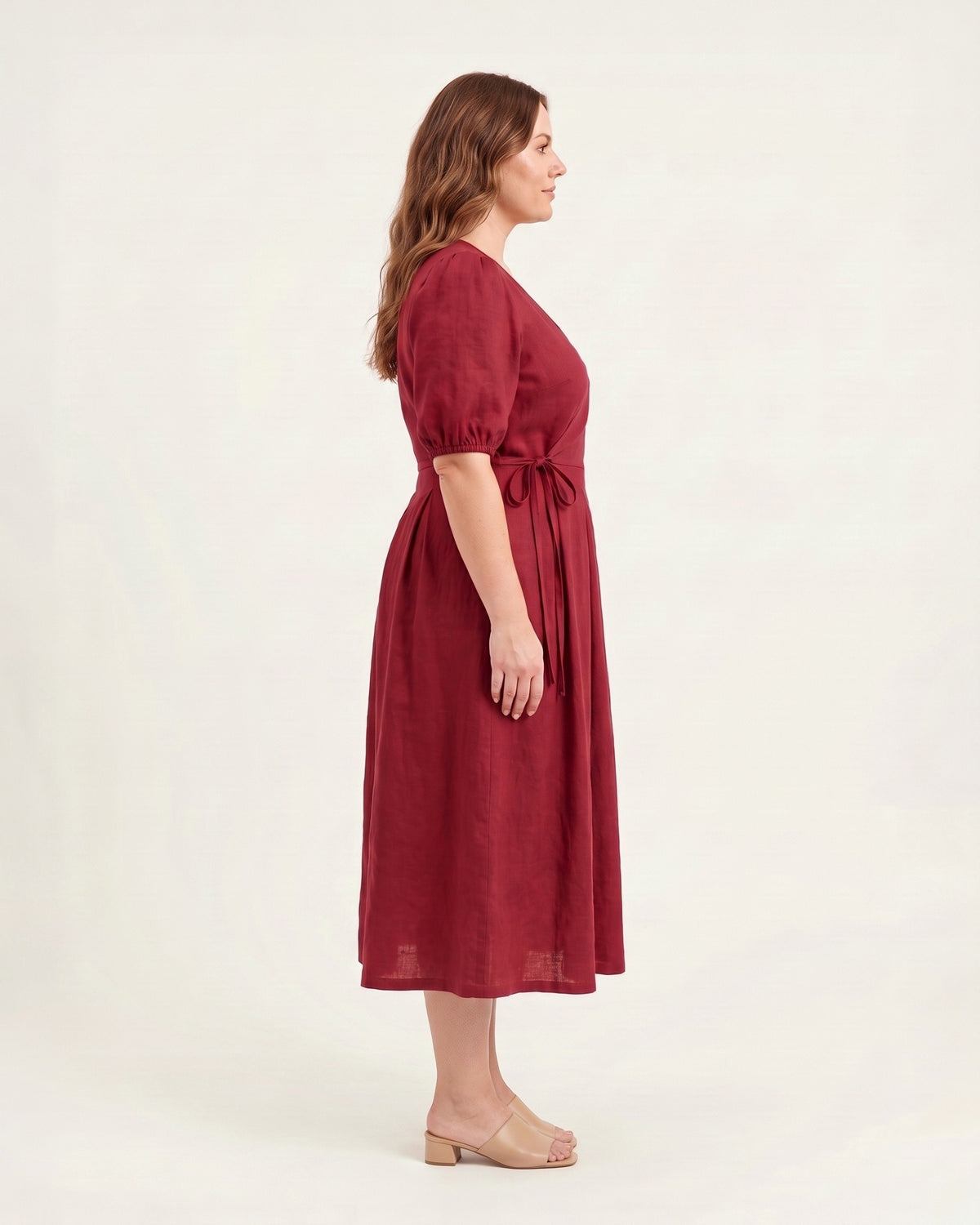 BONNIE SUPERSTAR – Linen Blend Puff Sleeve Tie-Waist Dress — Plus Size – cerise linen dress, full-length side view in the studio #Color_Cerise