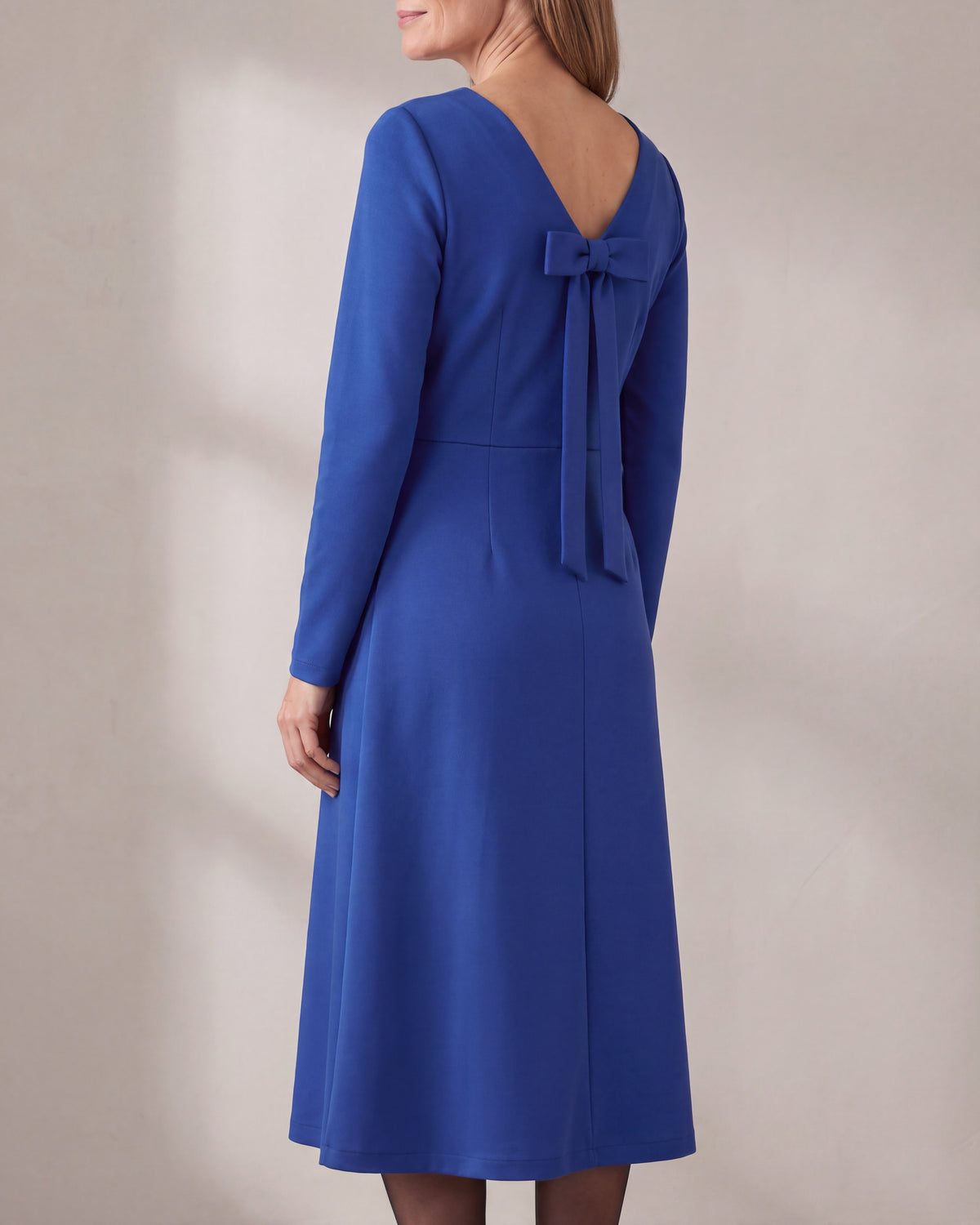 CLARA Punto Milano midi dress in Cobalt, back view with the narrow detachable bow at the shallow V
