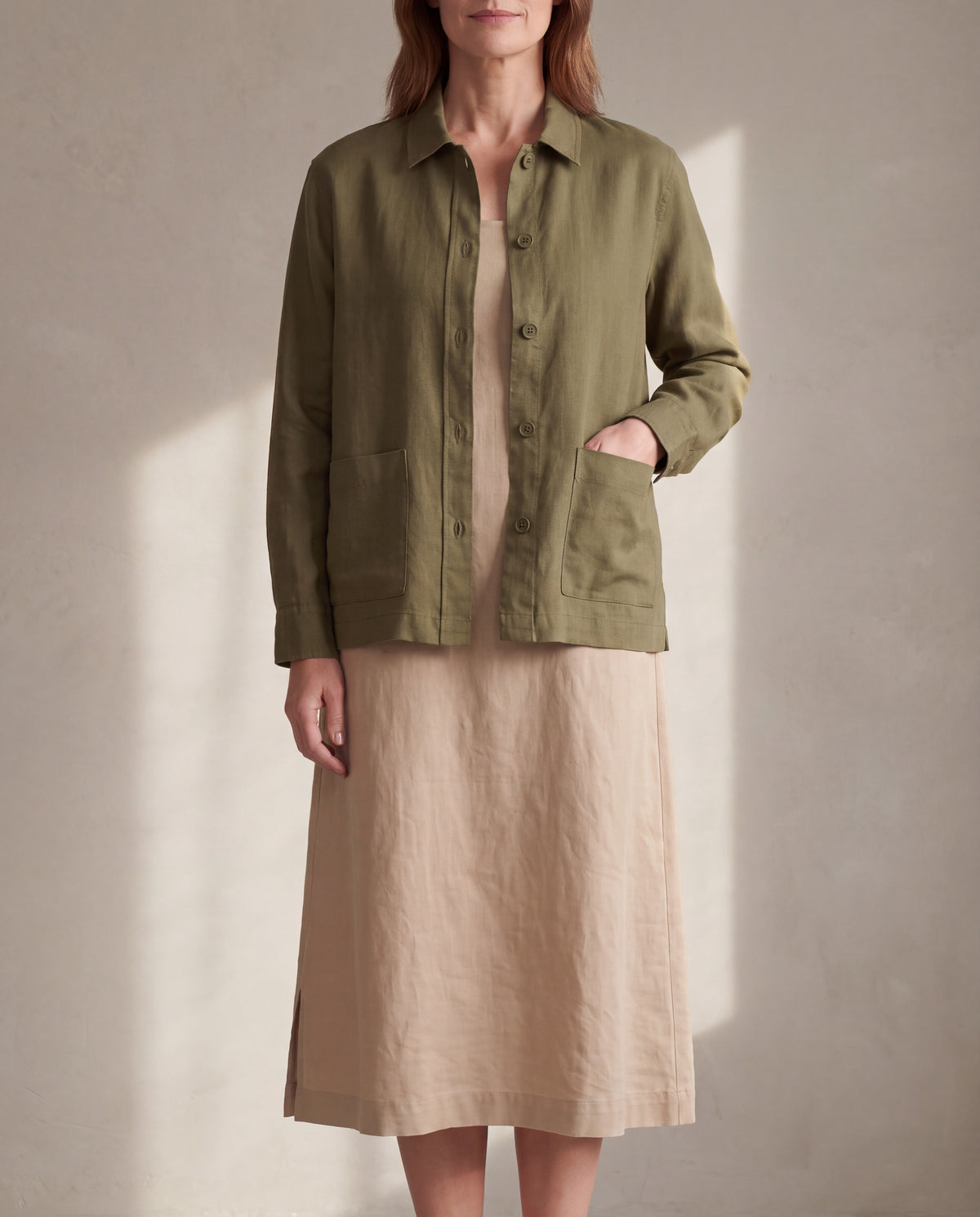 COVER linen shirt jacket in Olive Green worn open over a linen midi dress