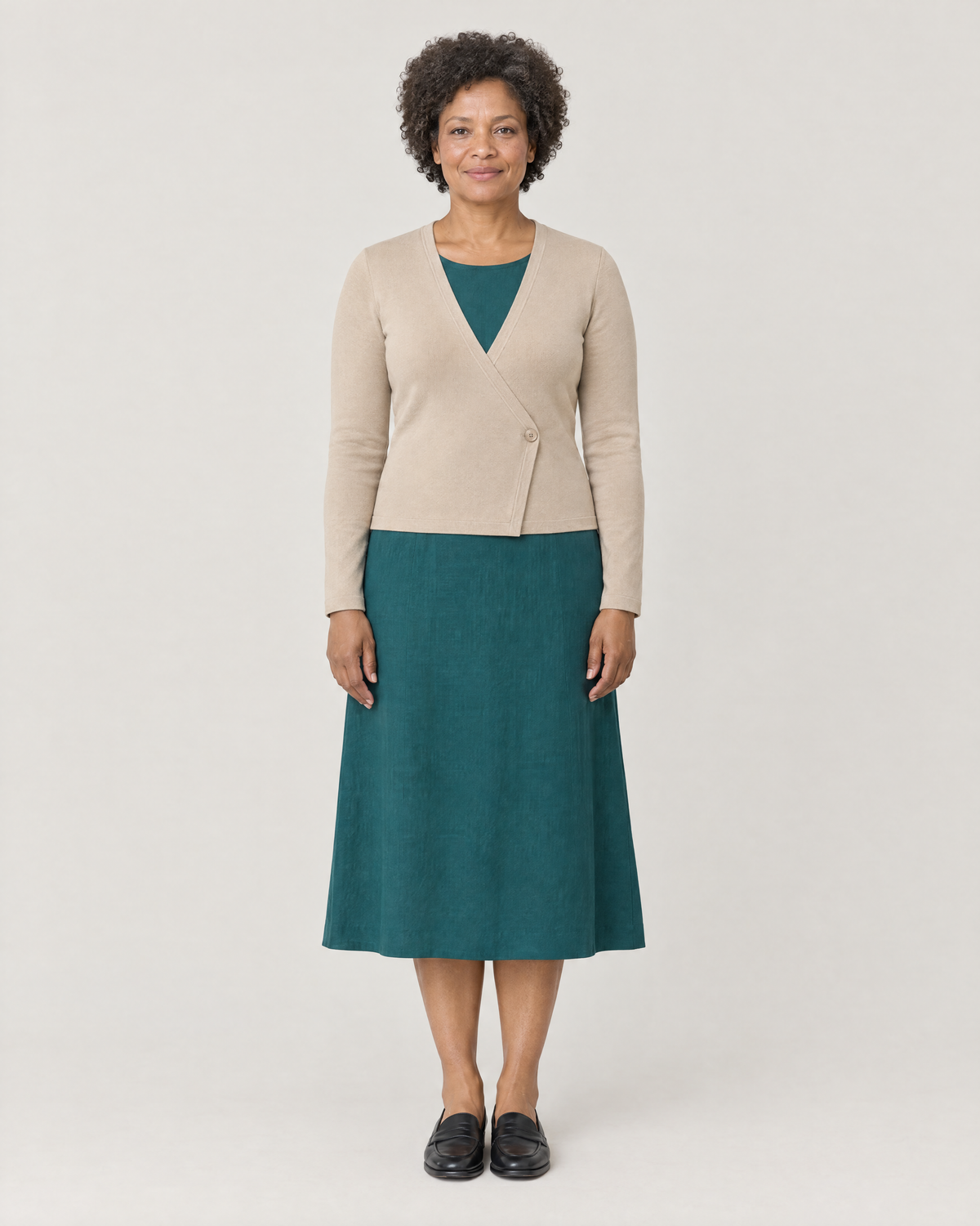 DRESS CARDIGAN beige wool wrap cardigan over a teal midi dress, front view