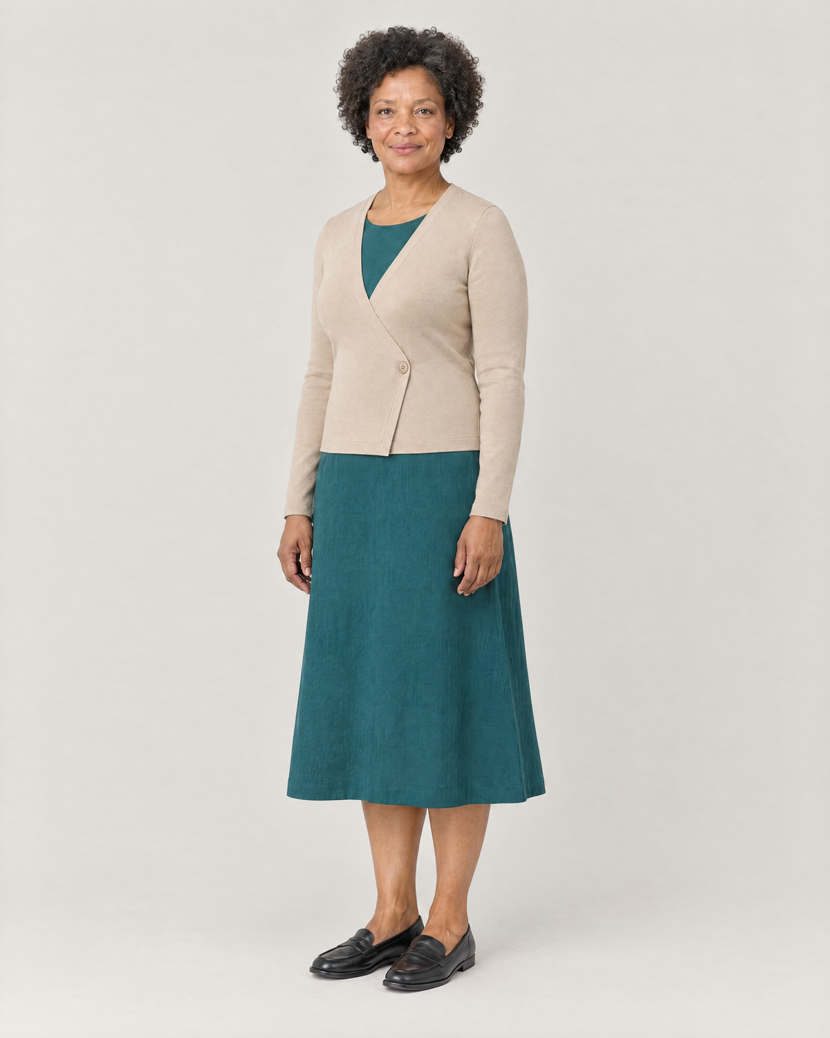 DRESS CARDIGAN beige, three-quarter view over a teal midi dress
