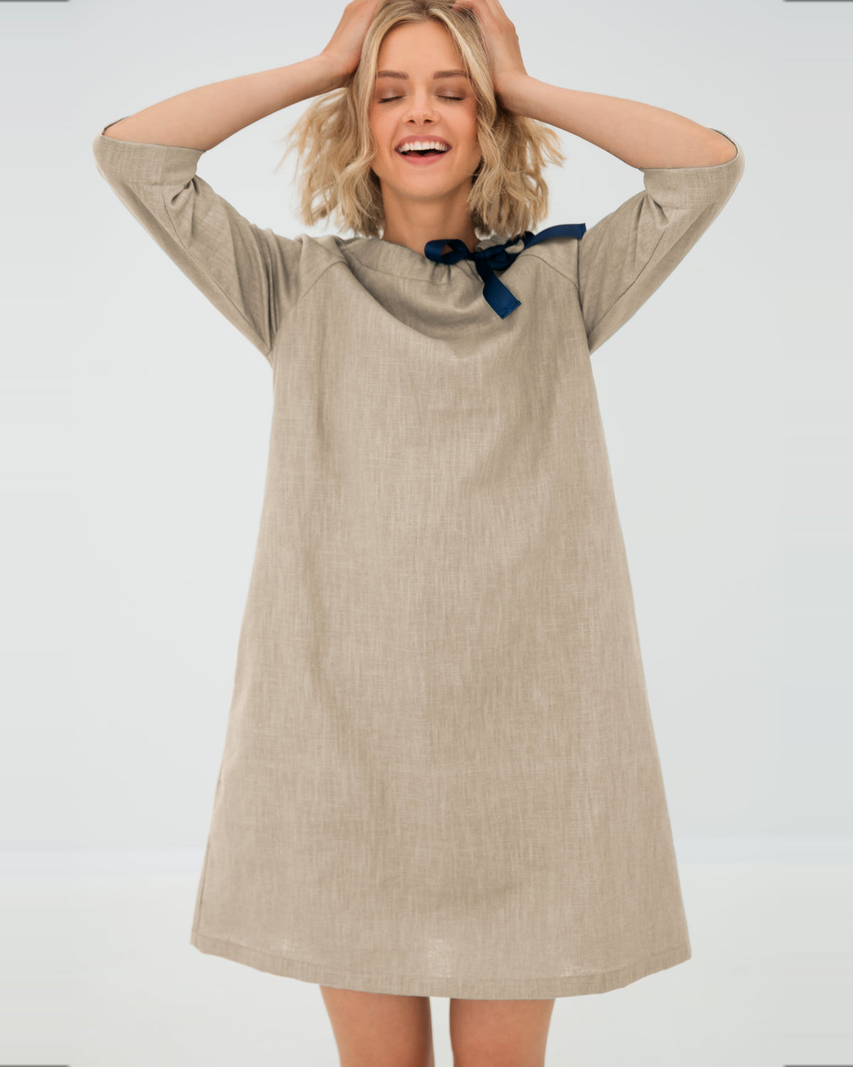 LeMuse FRENCH linen dress in beige – model hands up in motion #Color_Beige