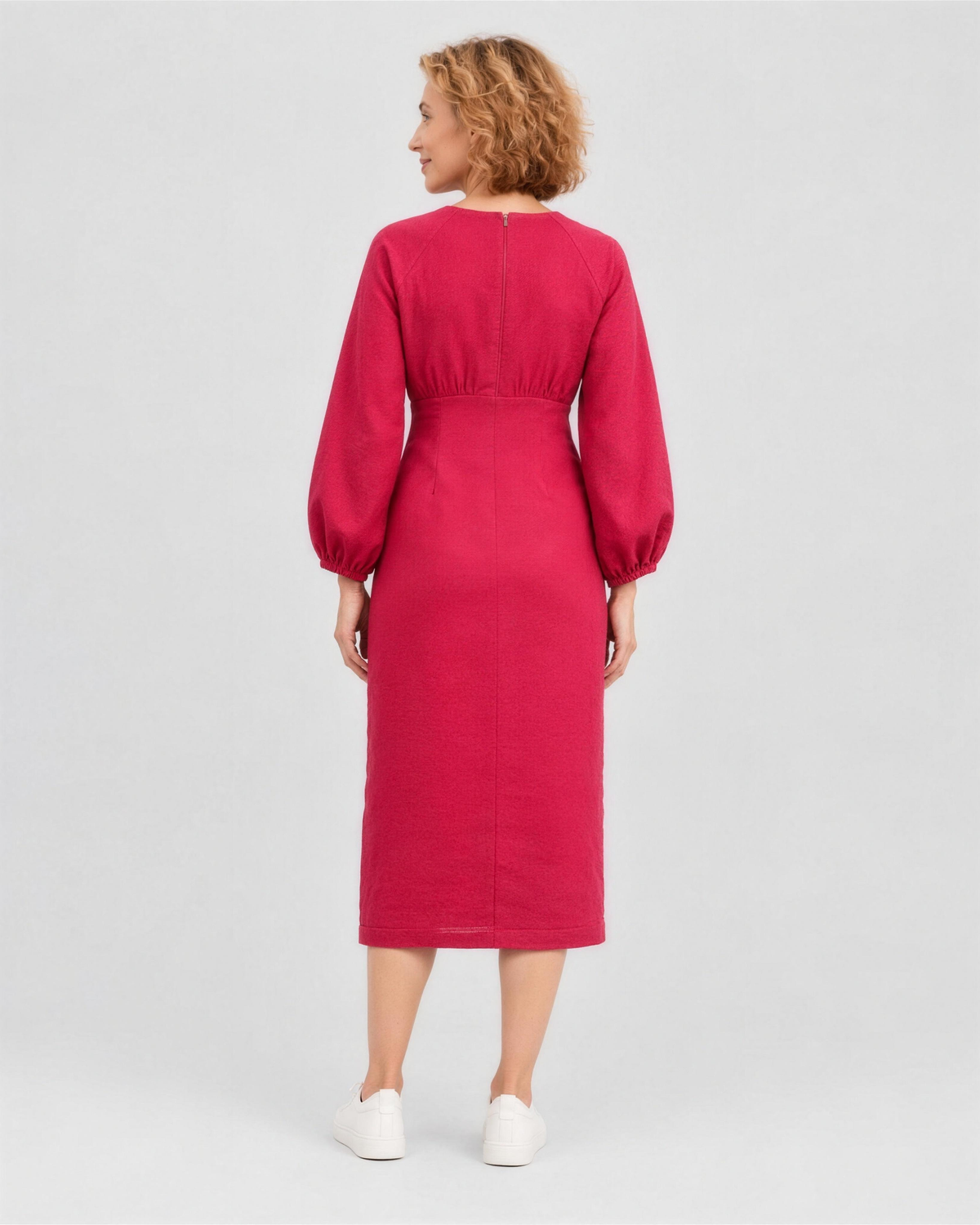 A woman viewed from the back in a studio, wearing a bright cerise red-pink linen midi dress with a gathered waist, full length. #Color_Cerise