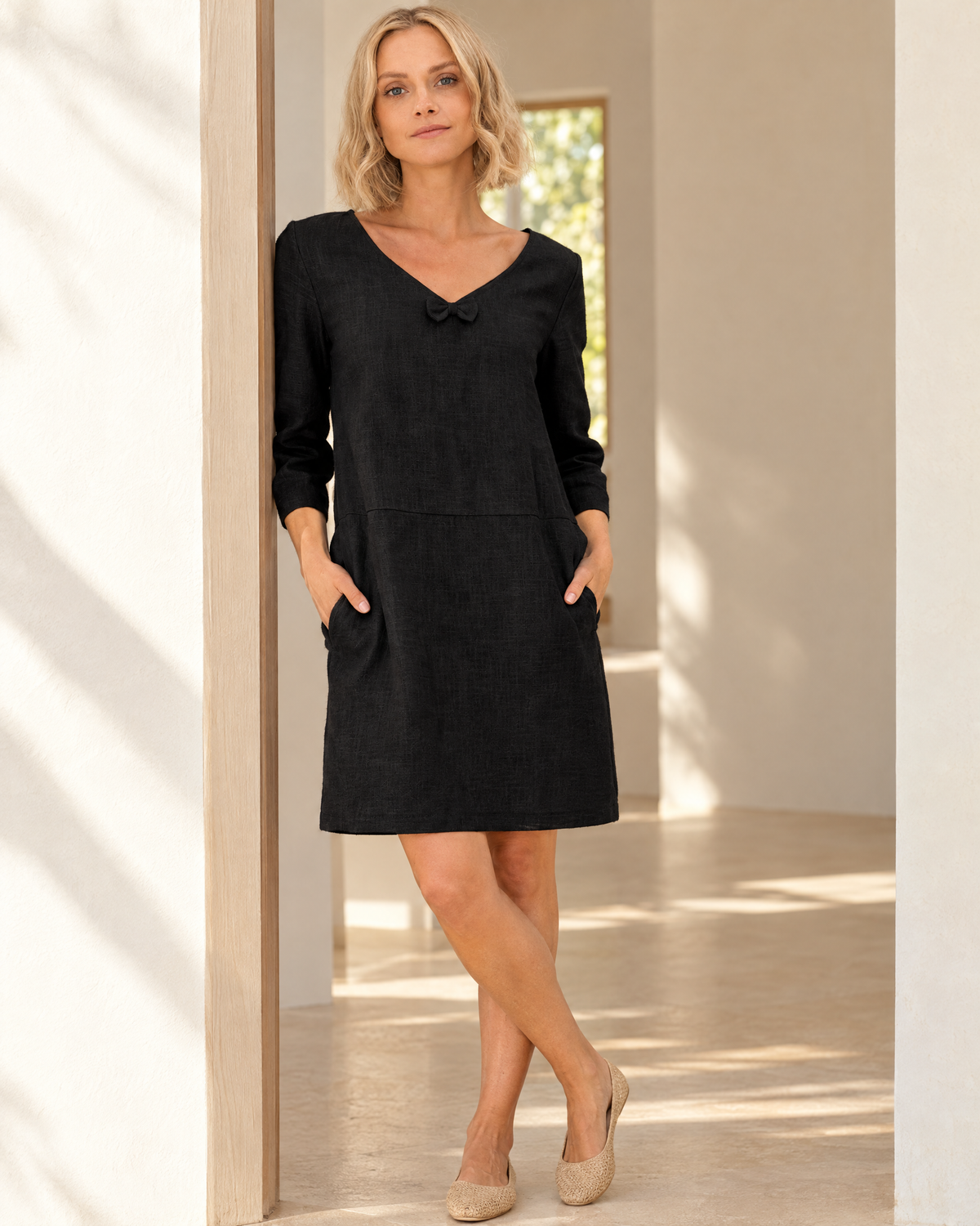 SUN – Linen Blend V-Neck Bow Dress – Black dress, lifestyle, sunlit doorway #Color_Black