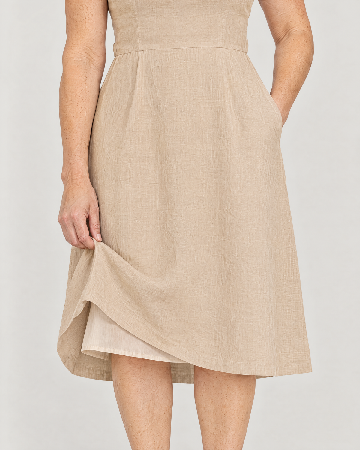 DAYLIGHT beige linen dress detail: cotton batiste skirt lining and side-seam pocket