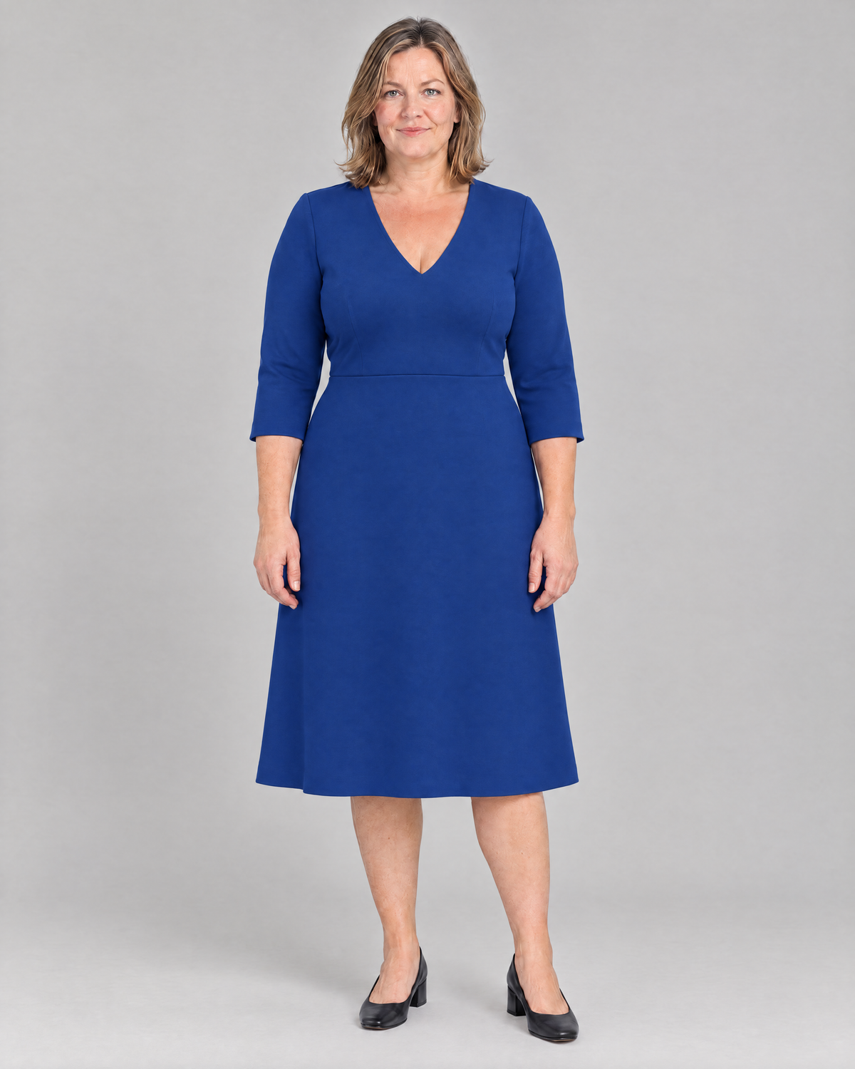 STORY CURVE Punto – cobalt blue V-neck A-line dress, front on model, full length
