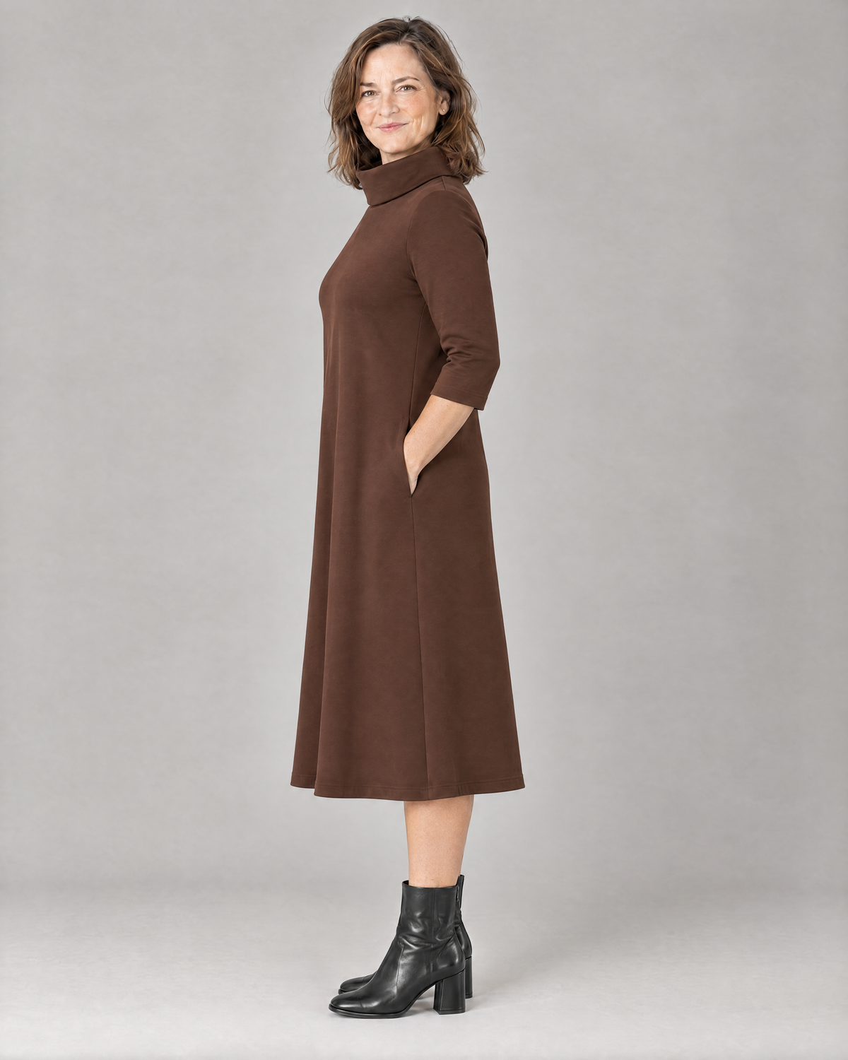 KIND A-line midi dress in Brown, side view showing mid-calf length and no waist seam