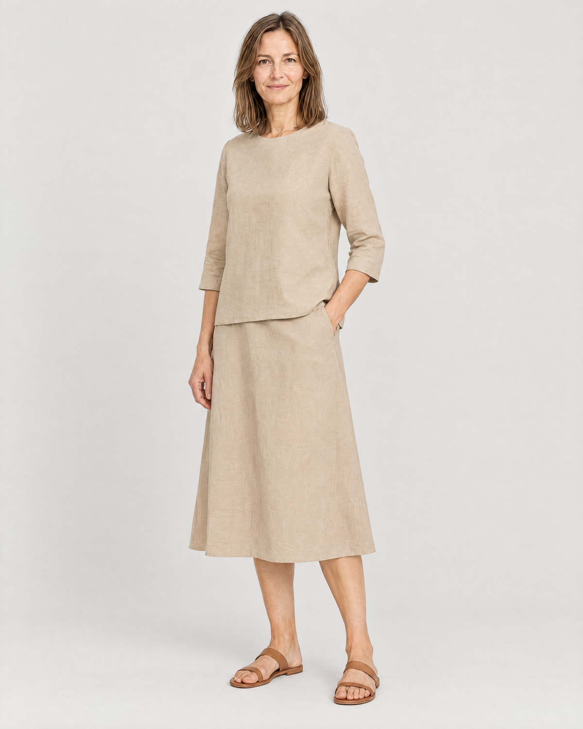 PAIR beige linen set, three-quarter view with a hand in the skirt pocket