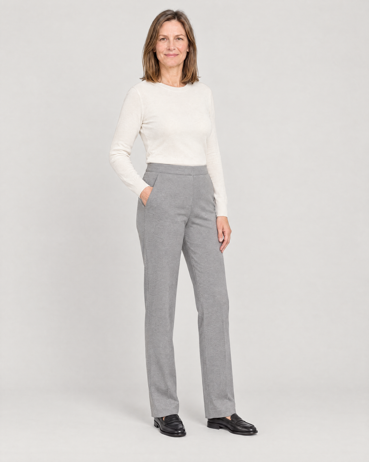 GRAPHITE COMFORT light grey trousers, three-quarter view with a hand in the slanted front pocket