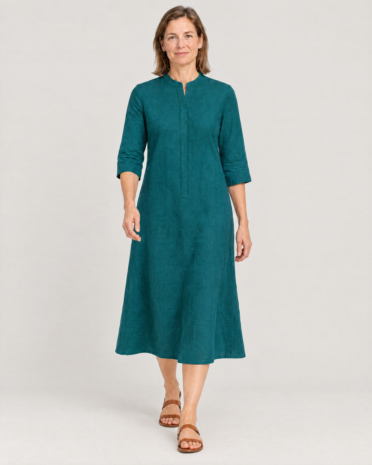 Woman walking in the SUMMER COLOUR teal linen A-line dress
