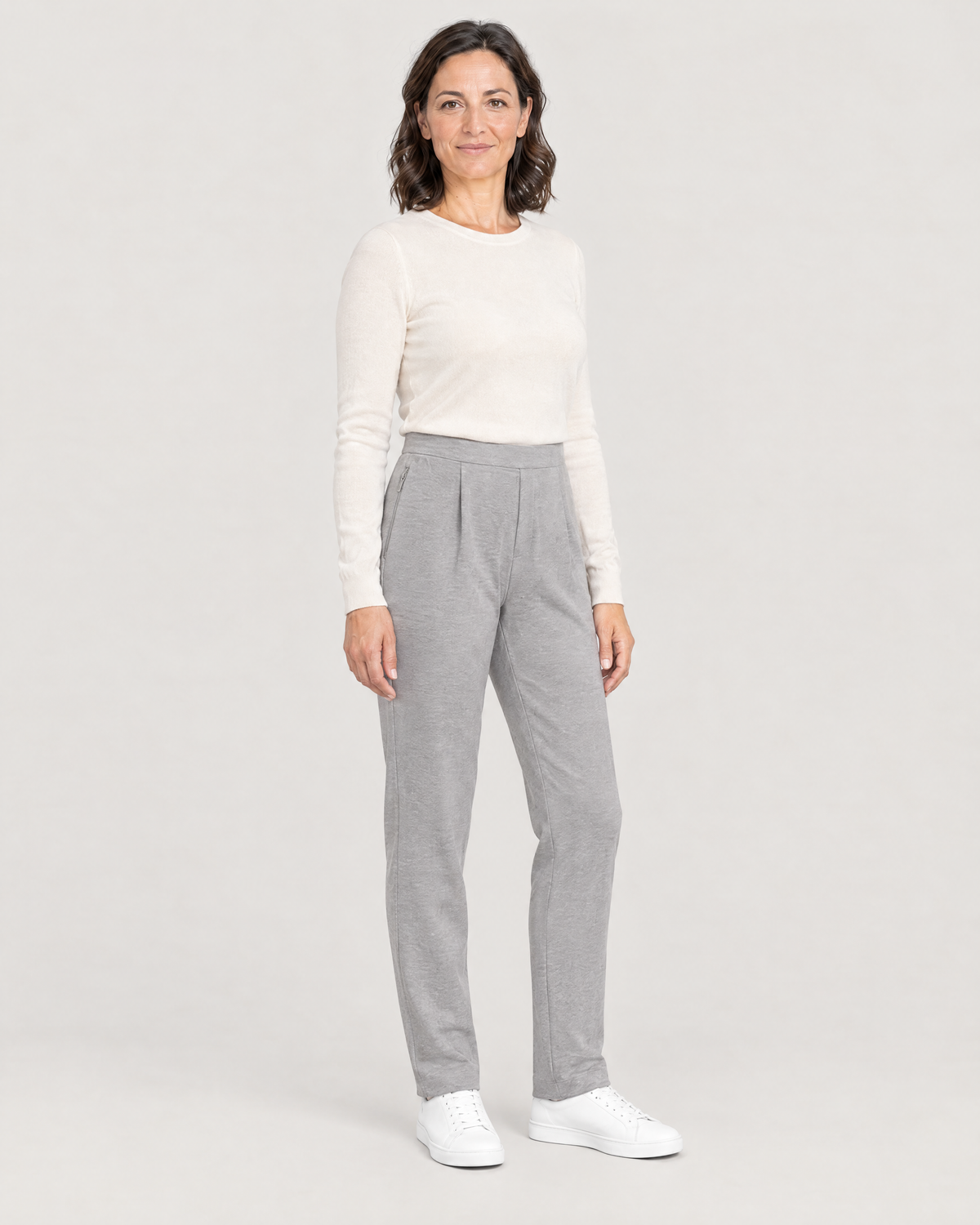 TRAVEL WARM light grey wool tapered trousers, three-quarter view showing the zipped pocket at the side seam