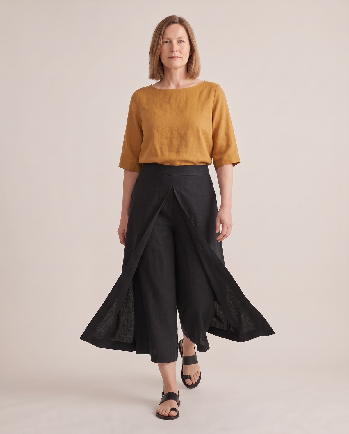 SWAY linen culottes in Black while walking, the pleat opens into two legs