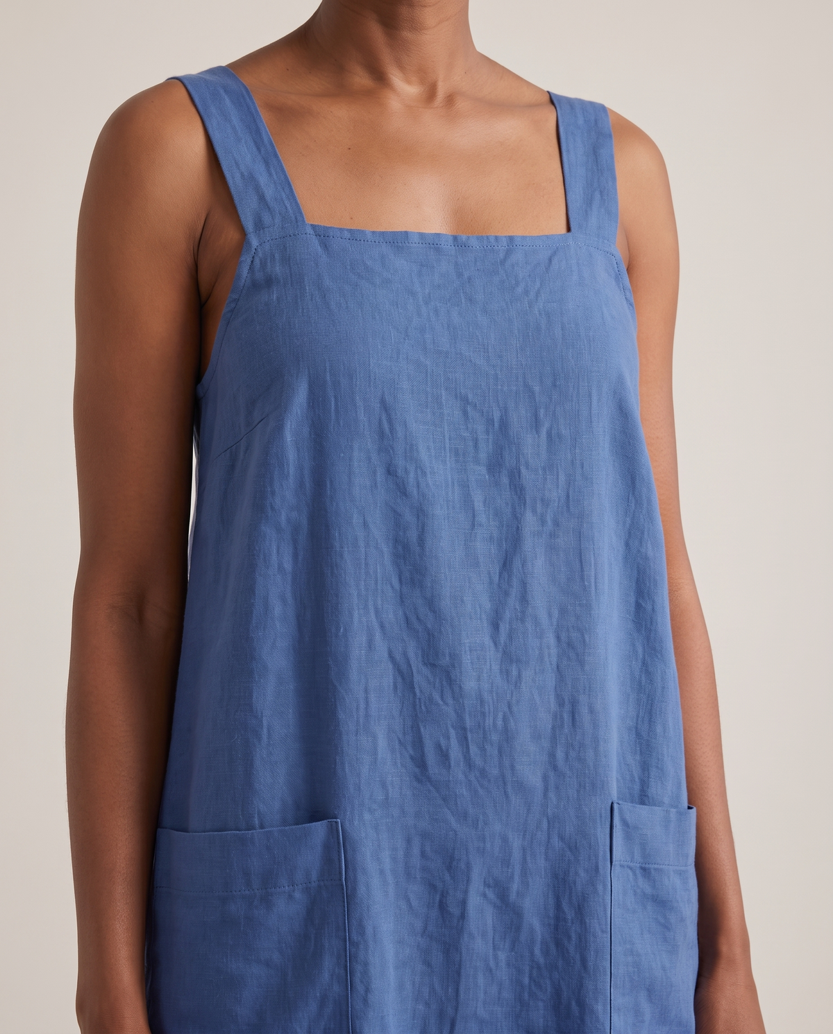 LAYER linen pinafore dress in Blue, neckline and pocket detail
