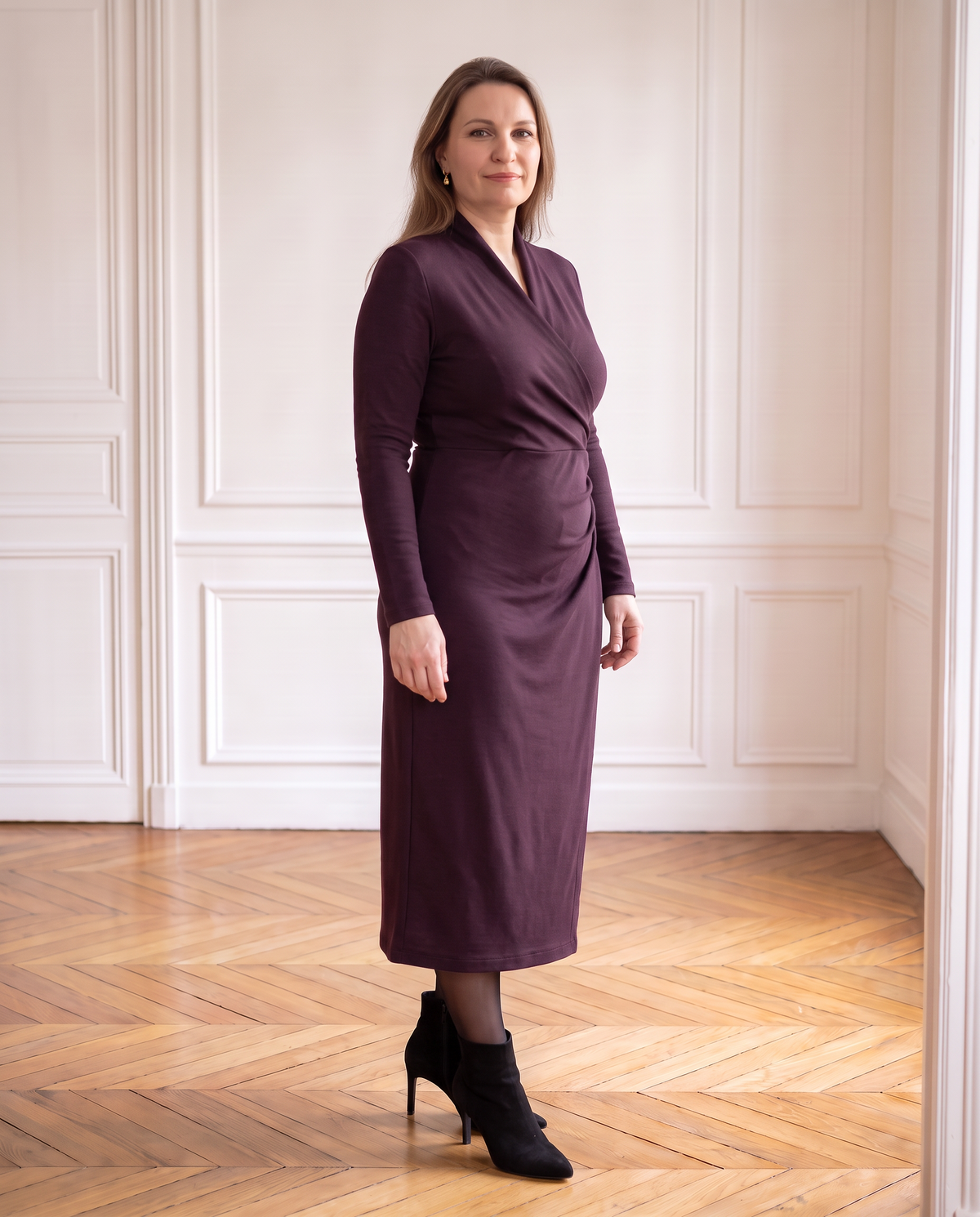INGRID aubergine merino dress, three-quarter view of the hip drape
