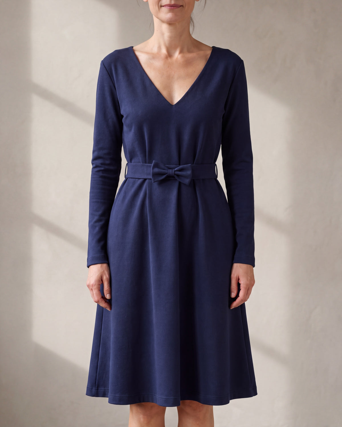 JAZZ Deep blue Punto Milano belted V-neck dress, close front view