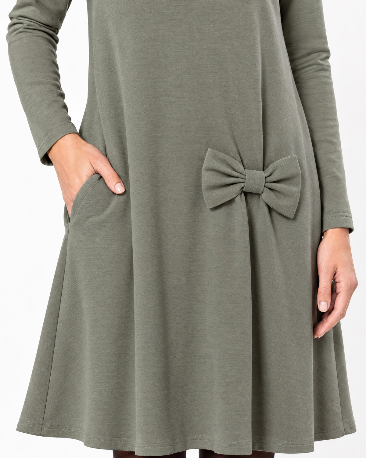 Close-up of a gray-green long-sleeve A-line dress showing the side pocket, bow detail and Punto Milano knit fabric texture. #Color_Gray green