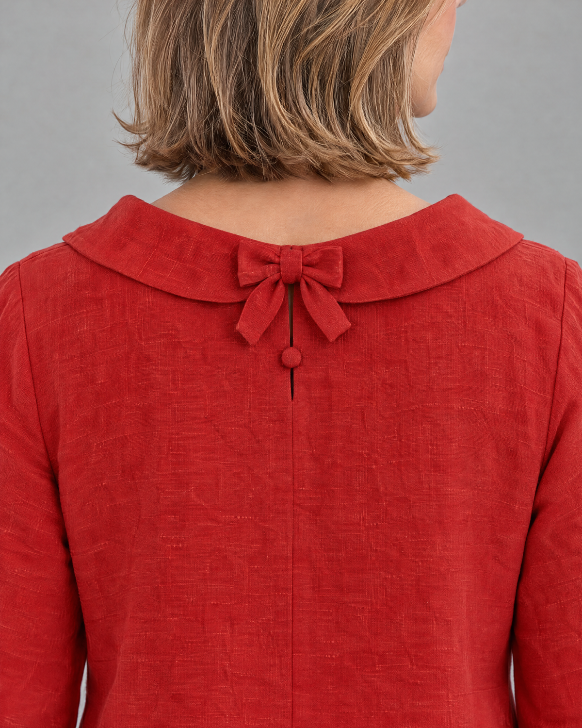 LILA linen back bow A-line dress in Red, close-up of the back bow and linen texture