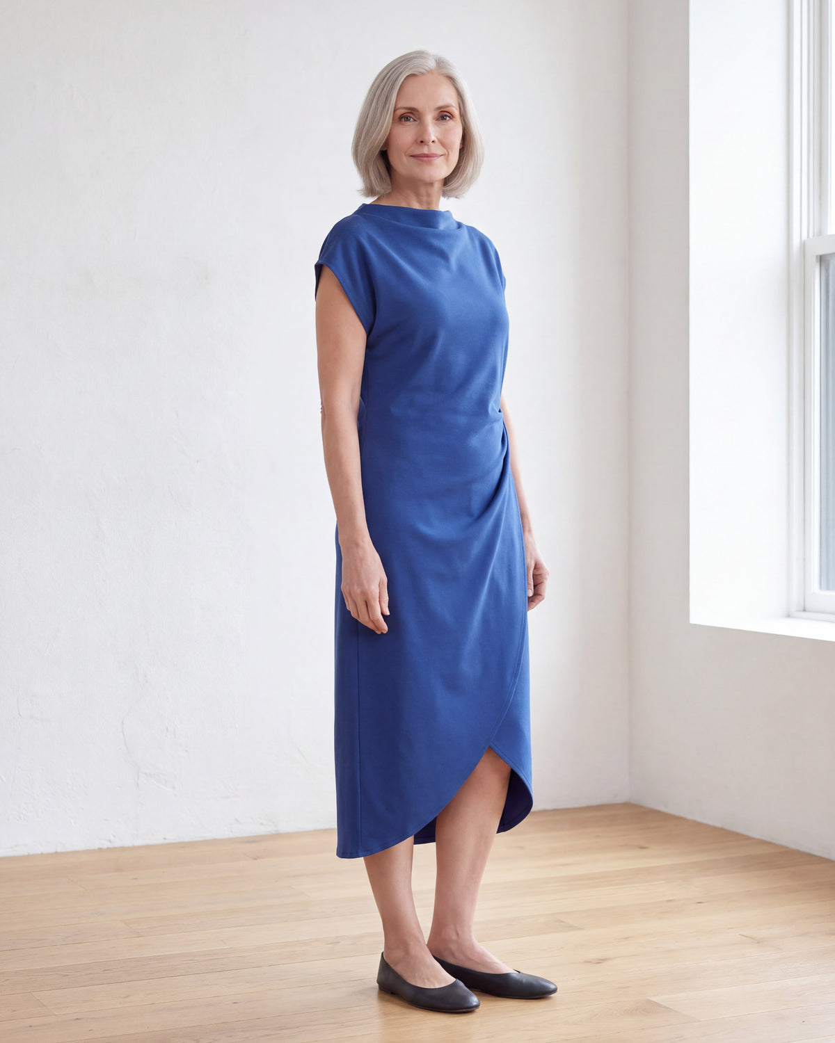 LIVIA cobalt dress, three-quarter view showing the tulip hem