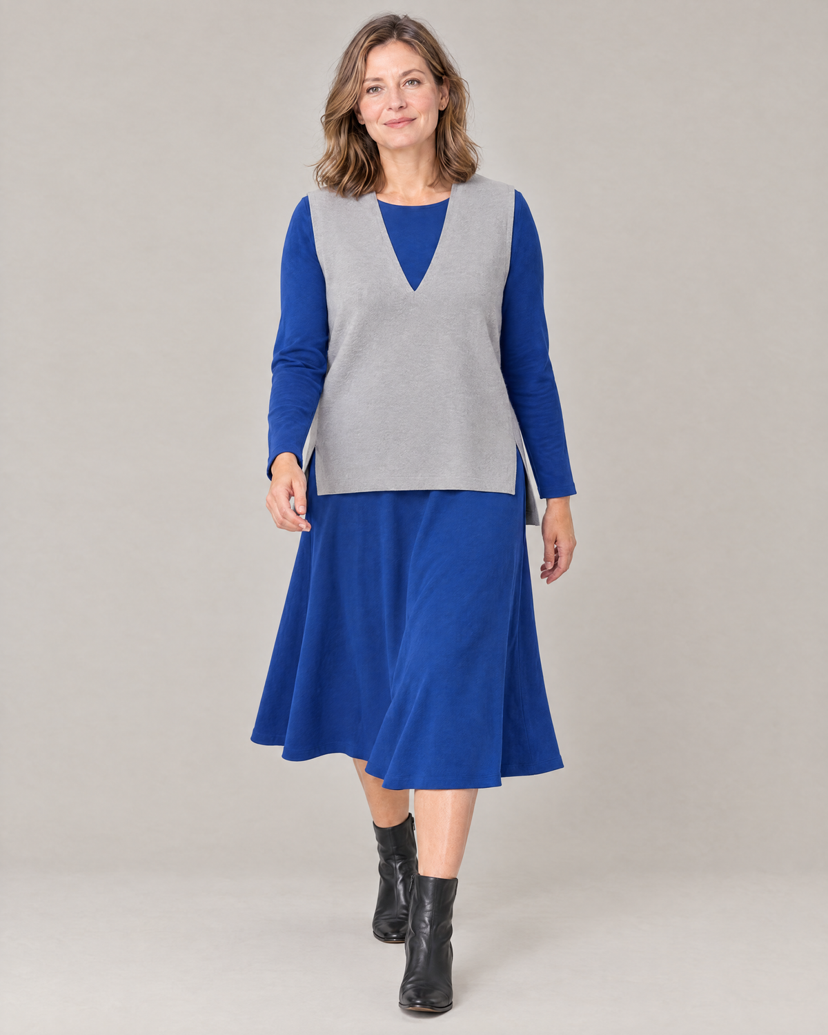 LIGHT VEST light grey worn over a midi dress while walking