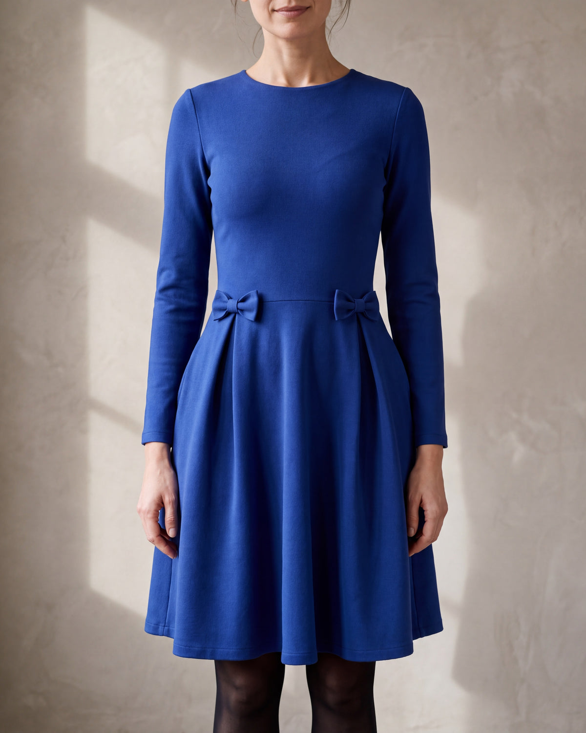 MADMUAZEL sapphire blue Punto Milano pleated bow waist dress, close front view