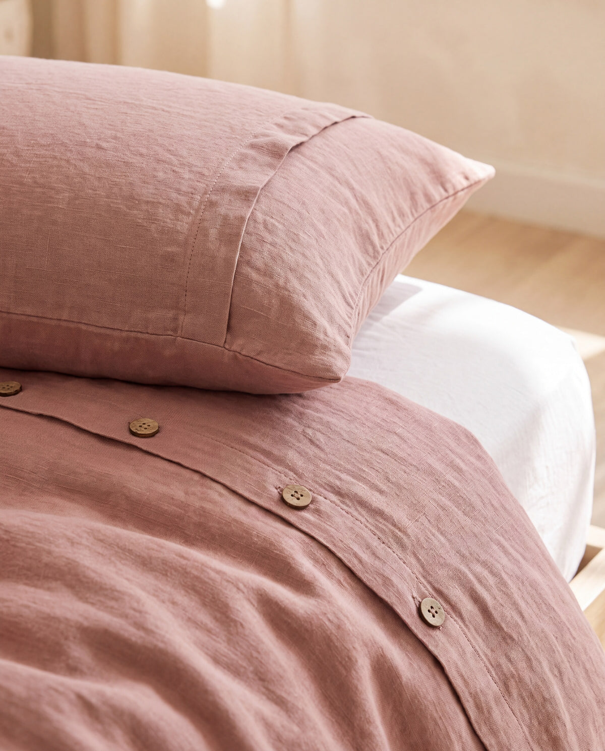 Linen pillowcase and duvet cover with coconut buttons