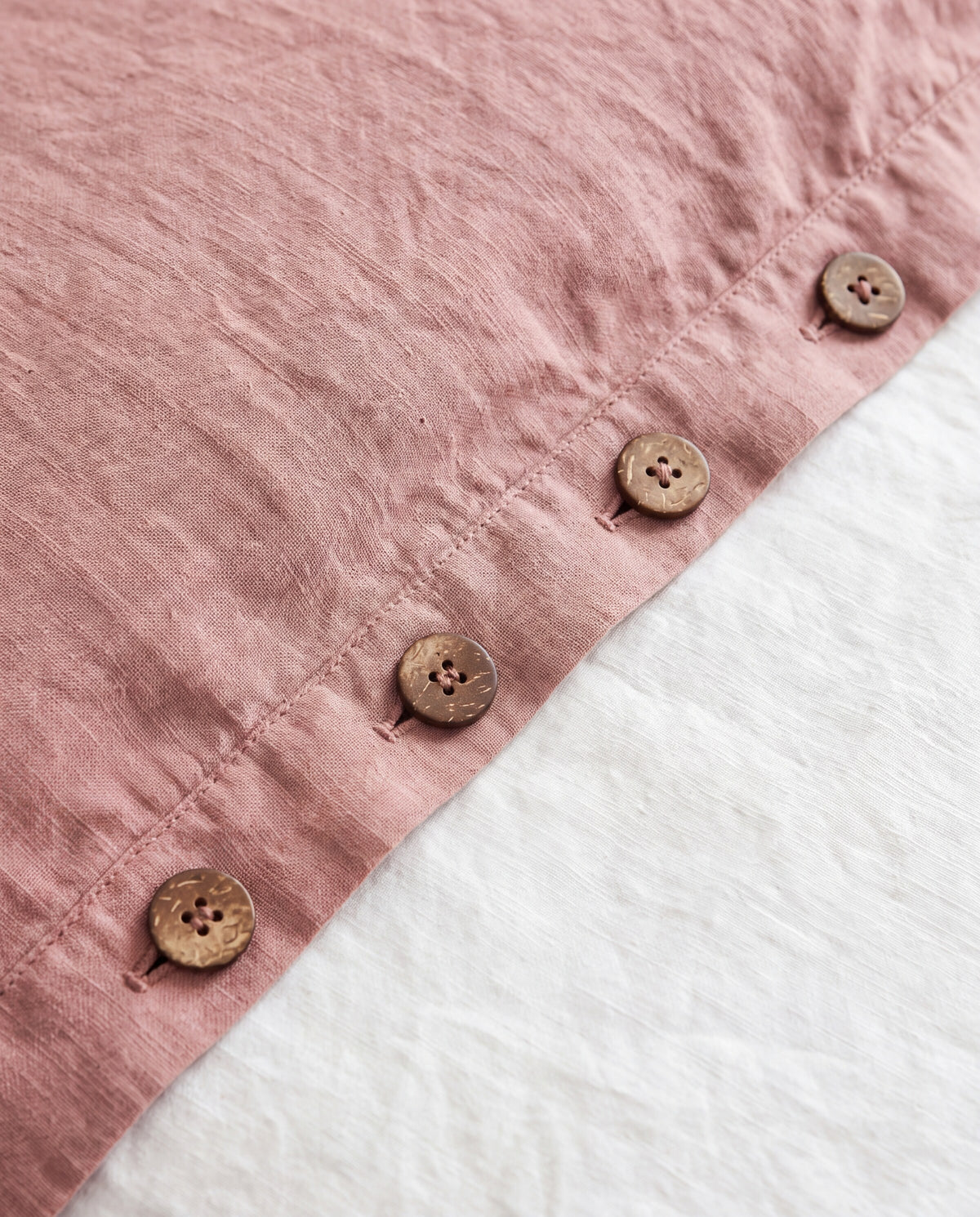 Coconut button closure at the bottom of the duvet cover