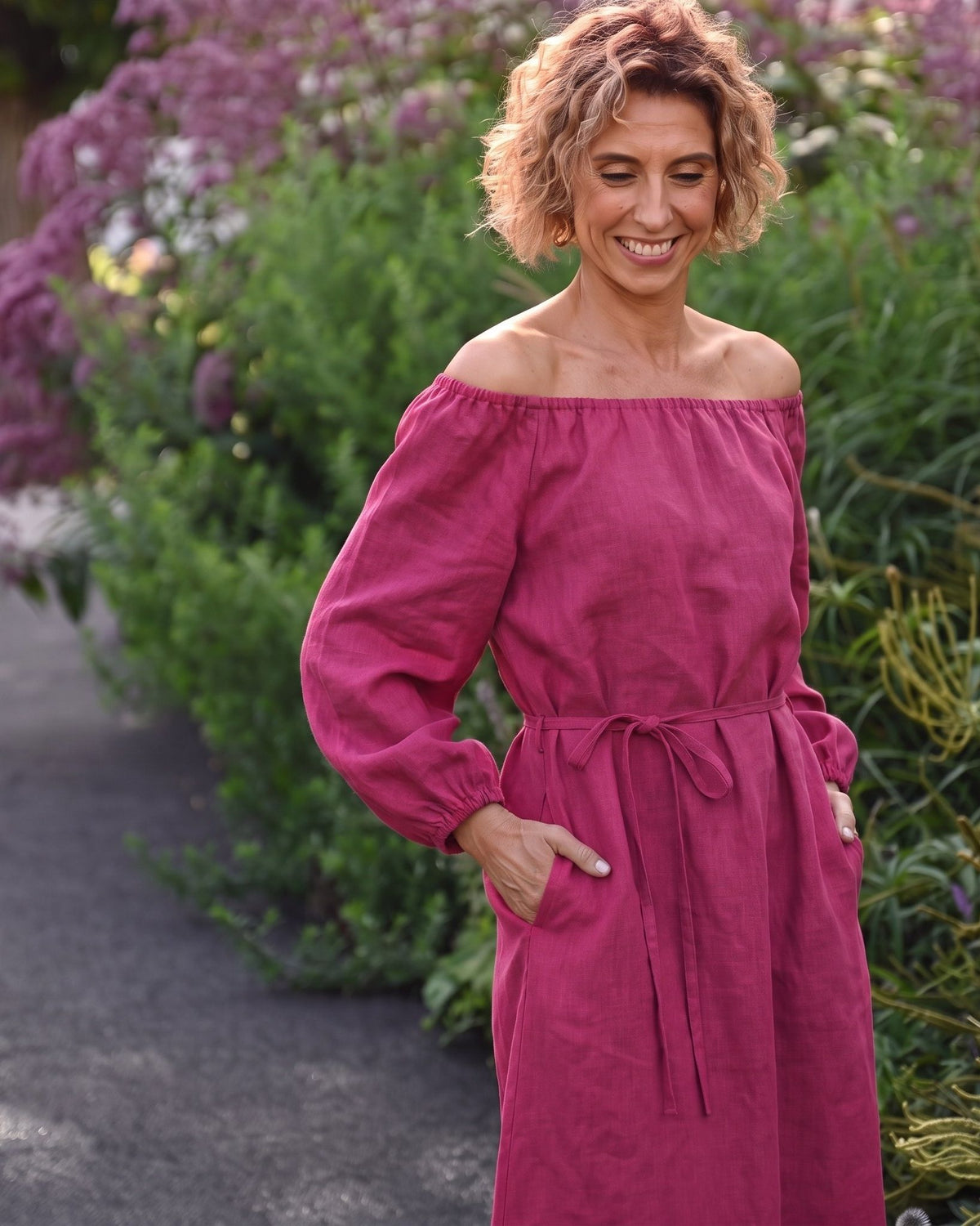 MOON – Cerise off-shoulder linen midi dress, lifestyle in a garden #Color_Cerise