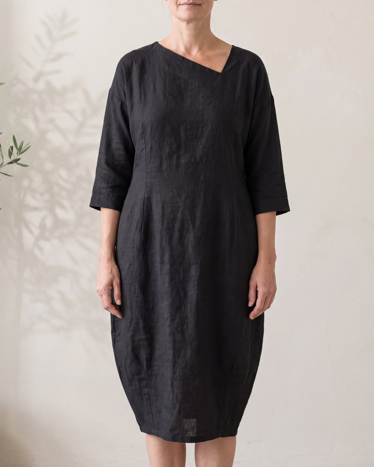 SHAPE black linen cocoon midi dress with asymmetric neckline, close front view