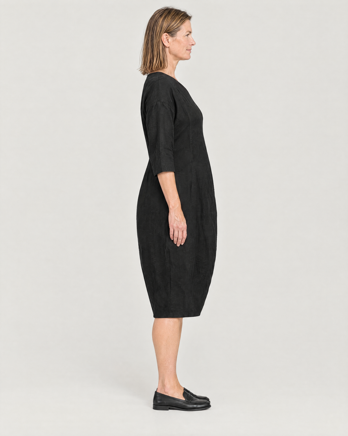 SHAPE linen cocoon midi dress in Black, side view showing the shape tapering to the hem