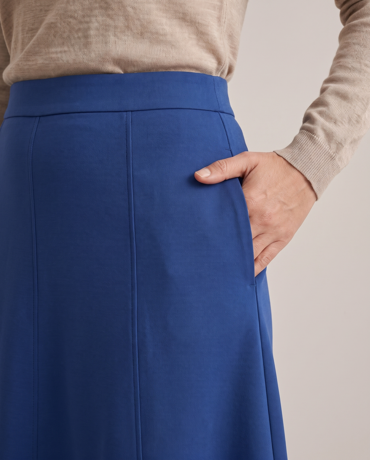 STEP skirt in Cobalt, detail of the flat waistband, panel seam and side pocket