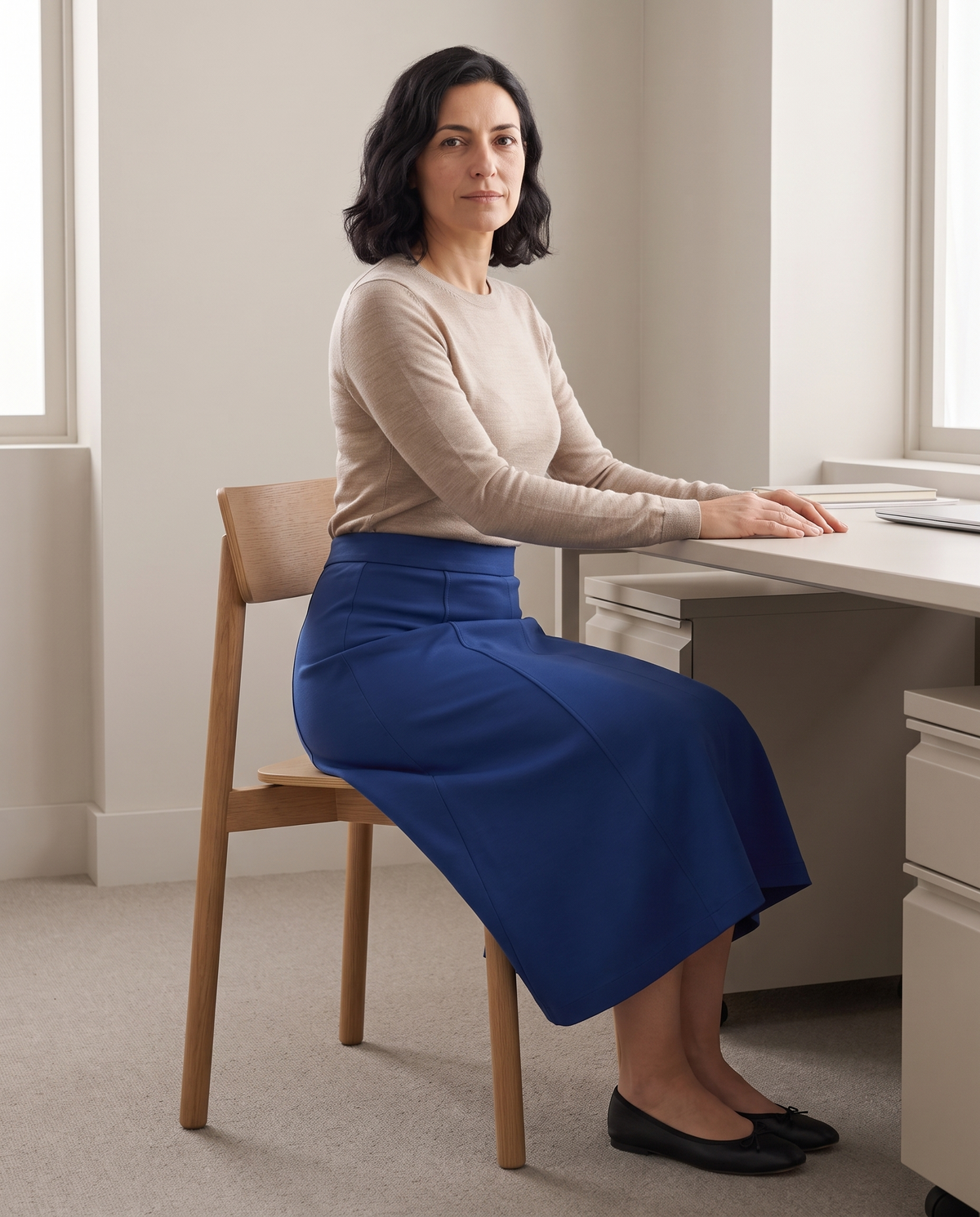 STEP midi skirt in Cobalt, seated at a desk