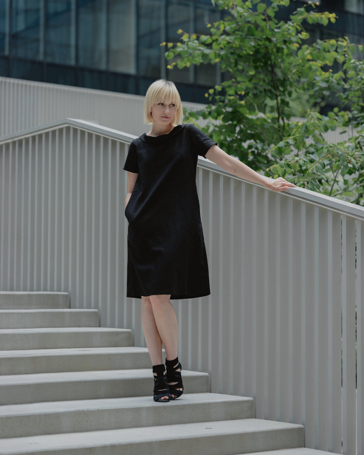LeMuse STORY linen dress in black – front full length on stairs #Color_Black