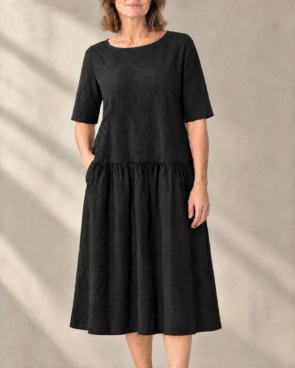 TESSA linen tiered midi dress in black with elbow-length sleeves, front