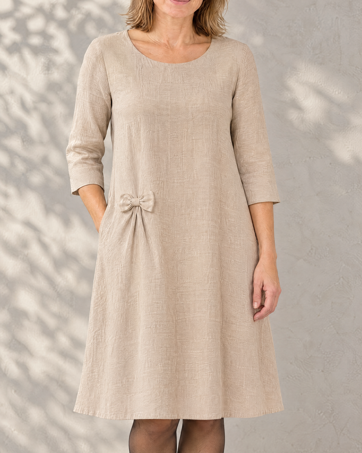 ADELE linen swing dress in beige with a small detachable hip bow, close front view