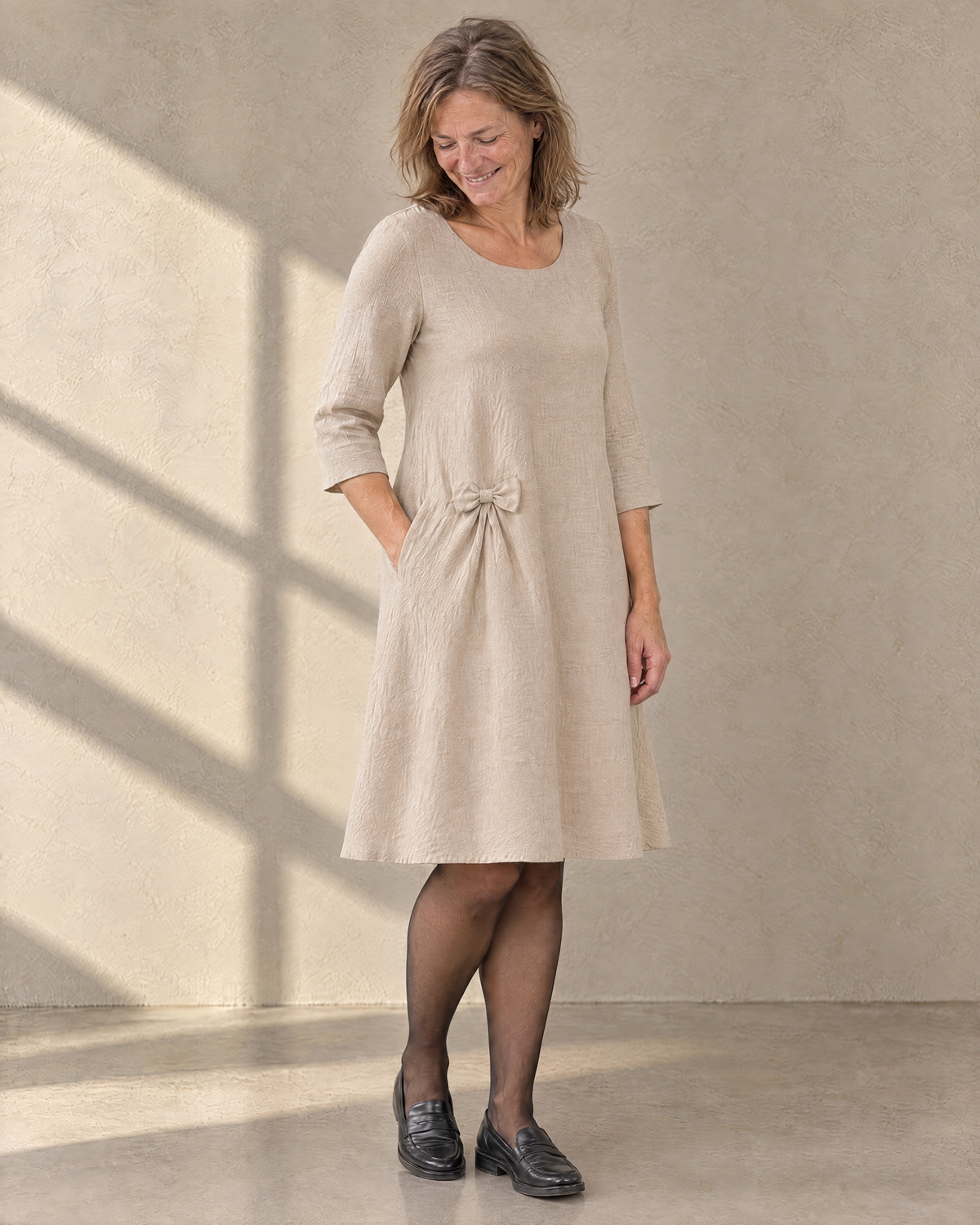 ADELE beige linen swing dress, three-quarter view showing the hip bow