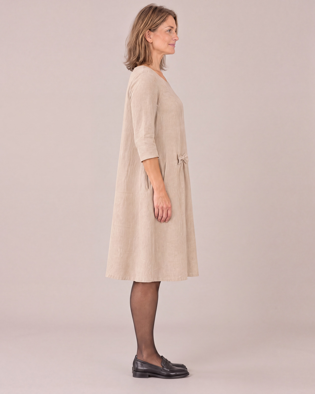 ADELE beige linen swing dress from the side, relaxed swing shape