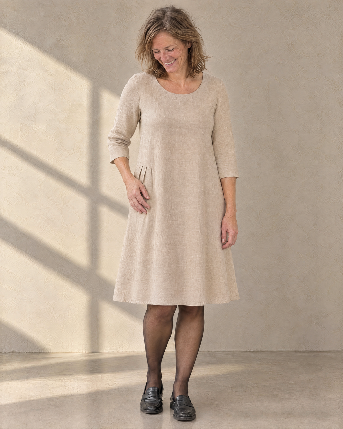 ADELE beige linen swing dress worn without the bow, soft tucks at the hip