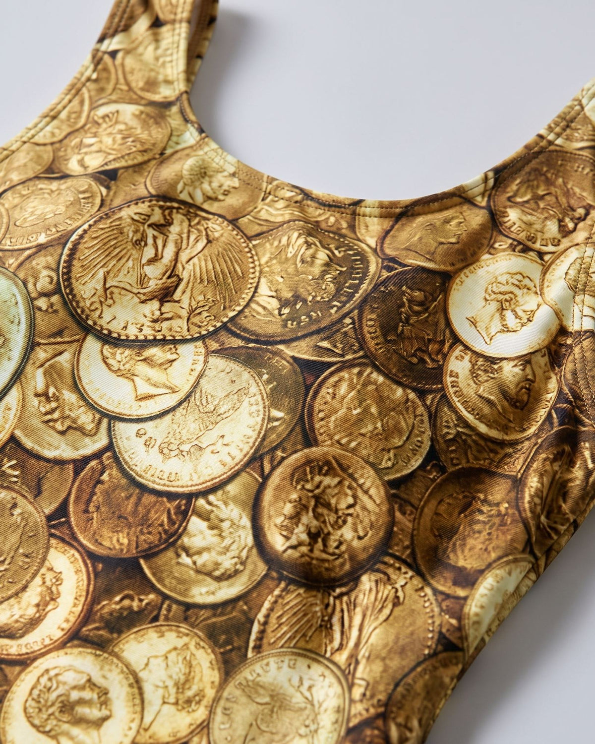 AURUM Gold Coin Print swimsuit – Gold, close-up detail of the coin print fabric and strap #Color_Gold
