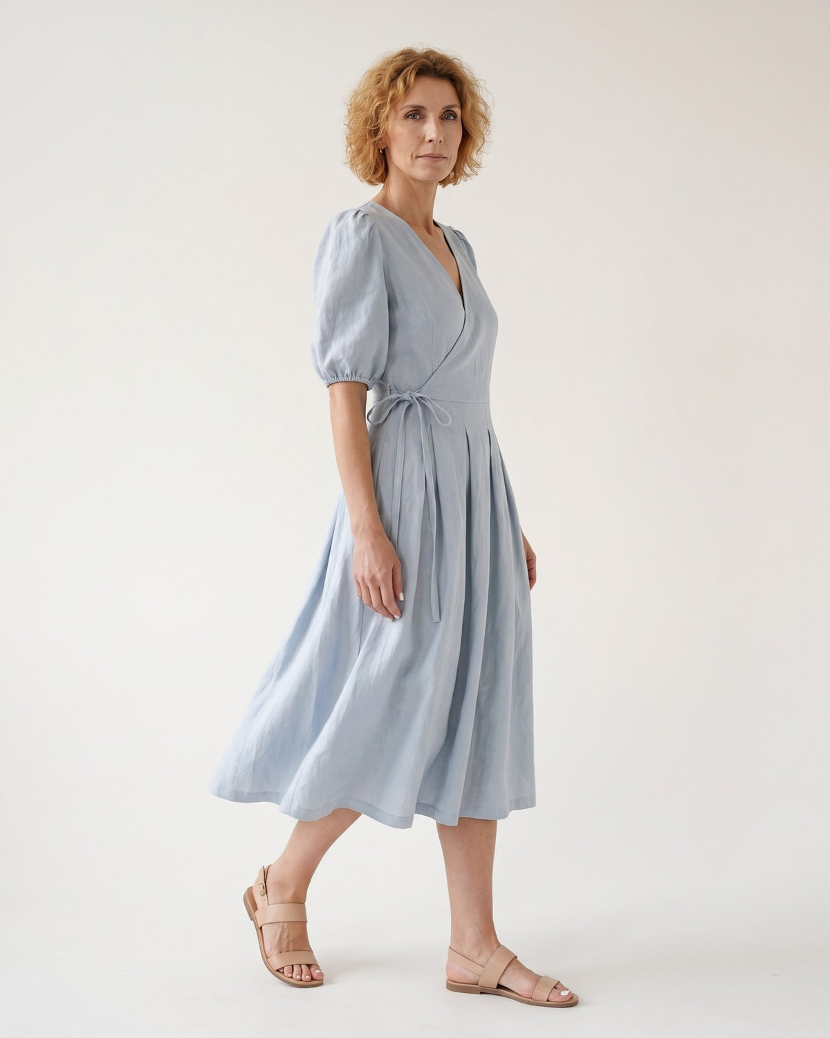 BONNIE – Linen Blend Puff Sleeve Tie-Waist Midi Dress – Light blue suknelė, side view in motion, full length in studio #Color_Light blue