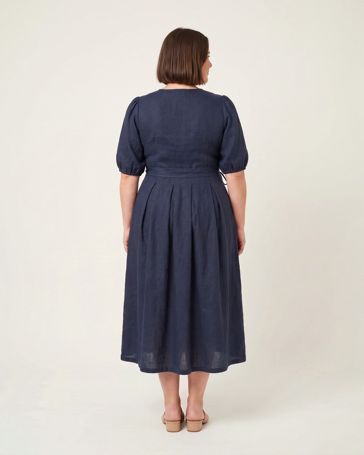 BONNIE SUPERSTAR – Linen Blend Puff Sleeve Tie-Waist Dress — Plus Size – deep blue linen dress, full-length back view in the studio #Color_Deep blue