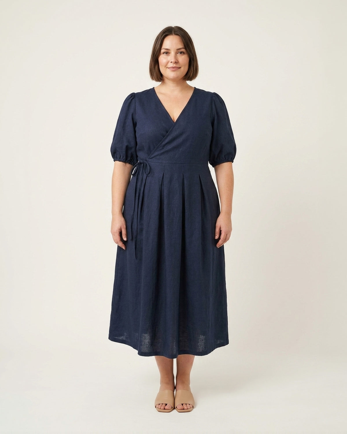 BONNIE SUPERSTAR – Linen Blend Puff Sleeve Tie-Waist Dress — Plus Size – deep blue linen dress, full-length front view in the studio #Color_Deep blue