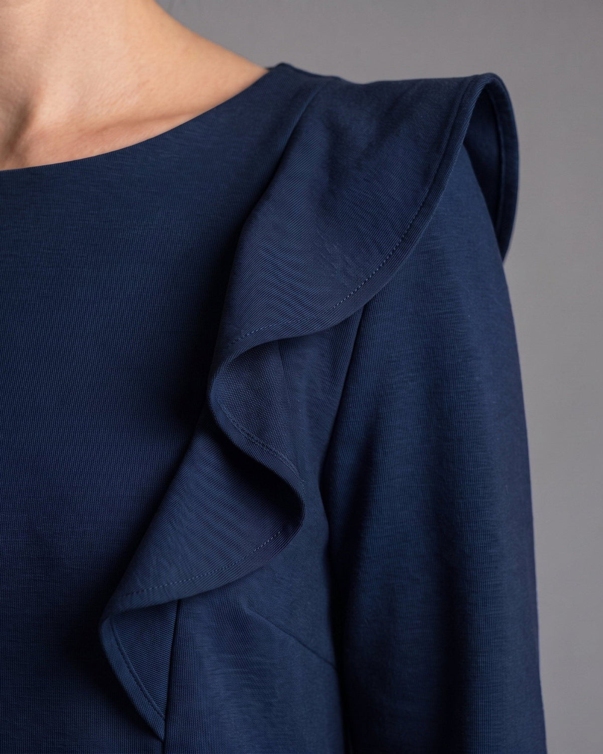 BUTTERFLY – Italian Punto Milano Ruffle A-Line Dress – deep blue dress, close-up of one of the two matching shoulder ruffles and the fine punto milano knit #Color_Deep blue