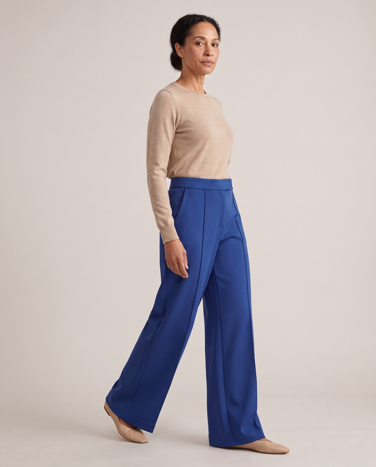 DORA cobalt wide-leg trousers from the side, walking