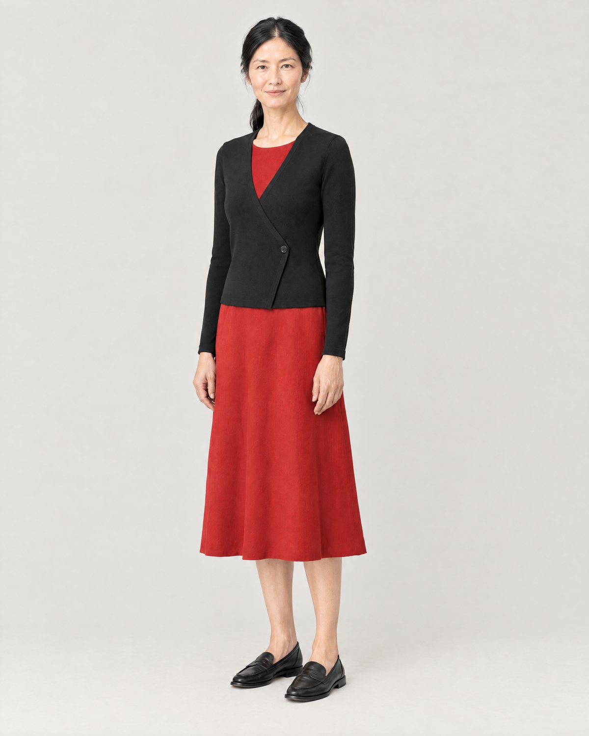 DRESS CARDIGAN black, three-quarter view over a red midi dress