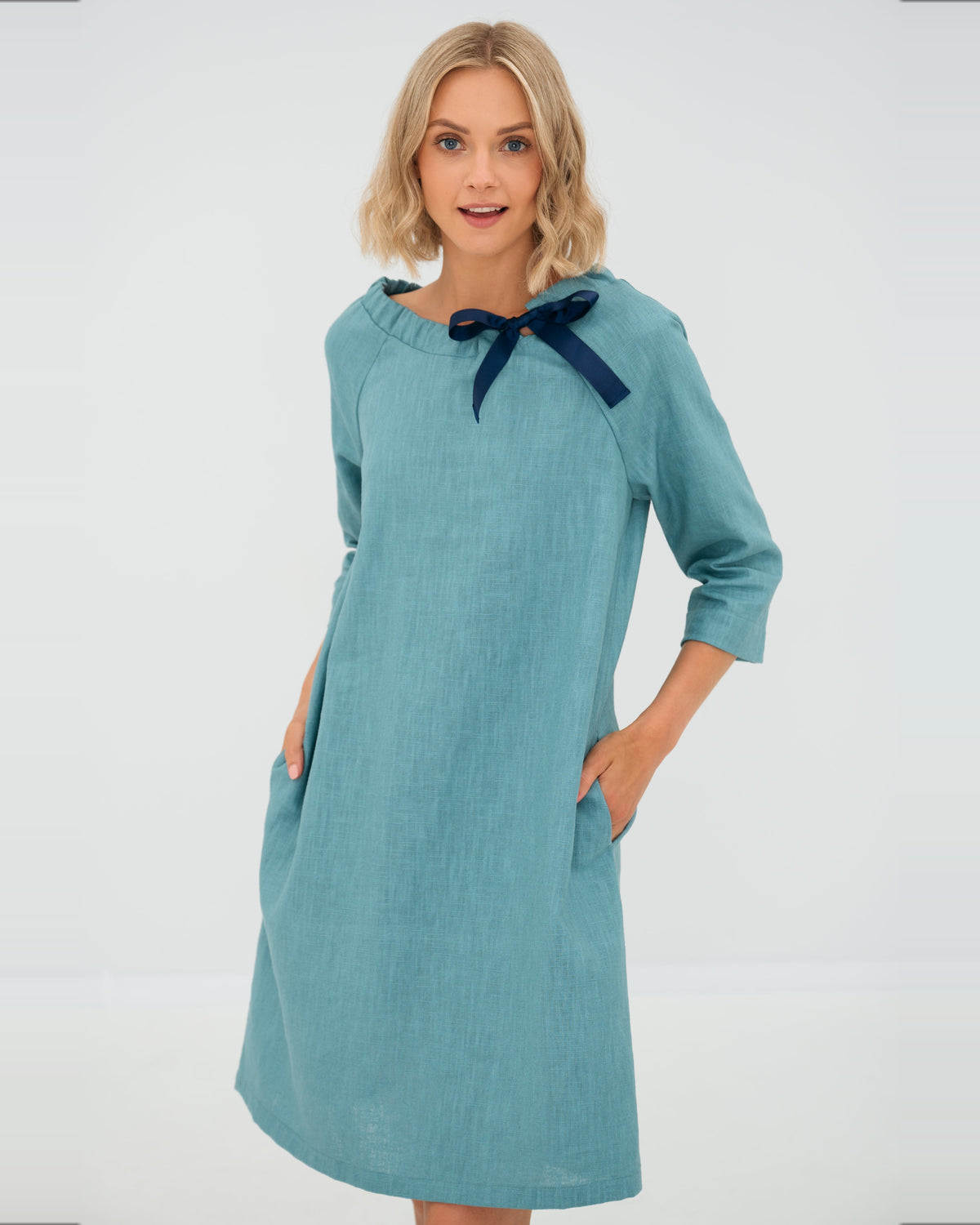 LeMuse FRENCH linen dress in teal – studio front view hand in pocket #Color_Teal